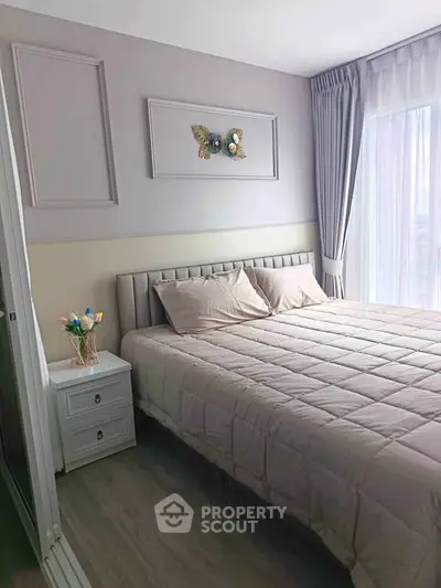 Cozy bedroom with elegant decor and large window for natural light