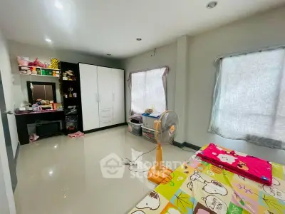 Spacious bedroom with modern wardrobe and natural light