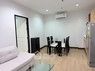 Modern living room with dining area and air conditioning in a stylish apartment.