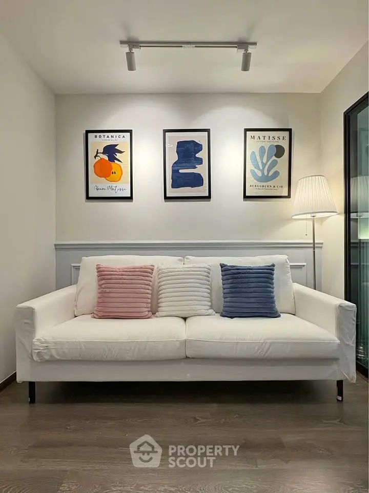 Stylish living room with modern art and cozy white sofa