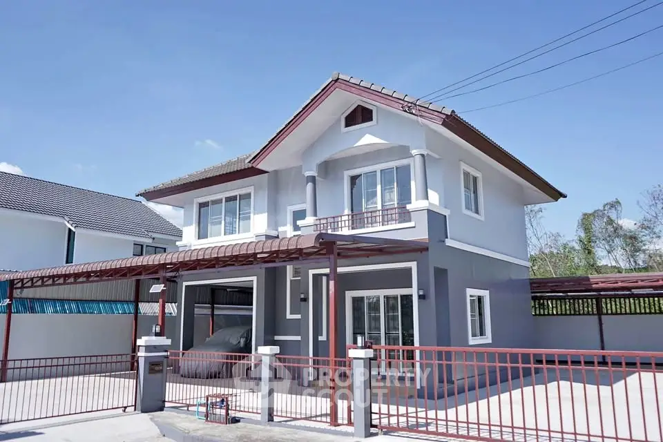 Charming two-story house with modern design and spacious driveway in a serene neighborhood.