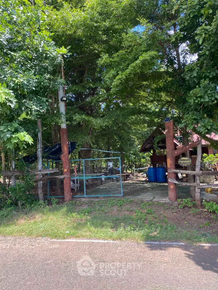 Charming rustic entrance to a serene garden retreat with lush greenery and inviting pathway.