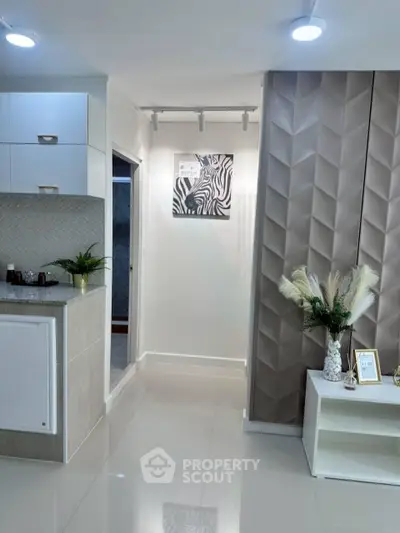 Modern interior with sleek kitchen and stylish decor in a contemporary apartment.
