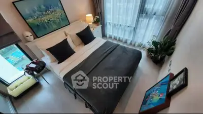 Modern bedroom with large window and stylish decor