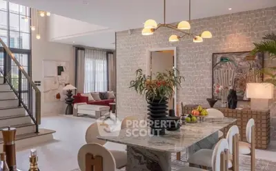 Luxurious open-plan living and dining area with modern decor and elegant lighting.