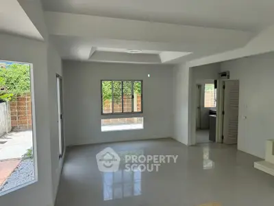Spacious living room with large windows and garden view in modern home