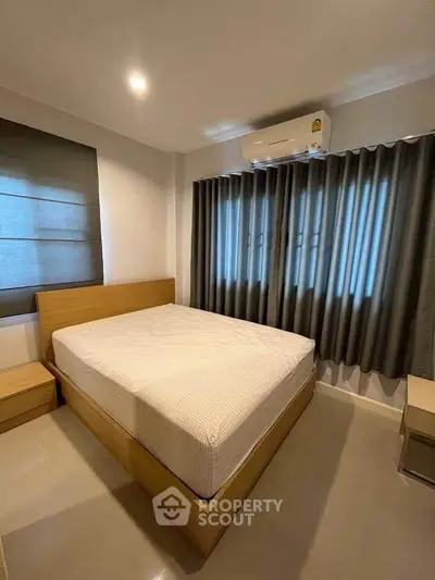 Cozy bedroom with modern furnishings and ample natural light