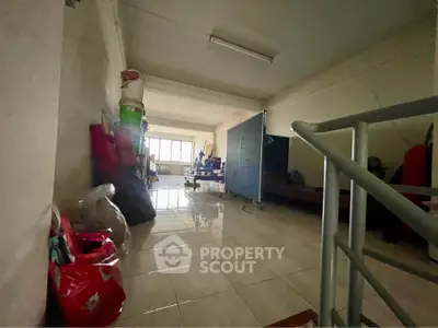 Spacious storage room with tiled flooring and ample natural light.