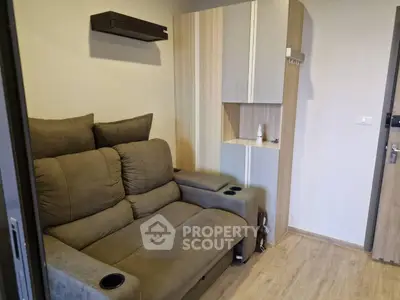 Cozy living room with plush sofa and modern wooden cabinet, perfect for relaxation.