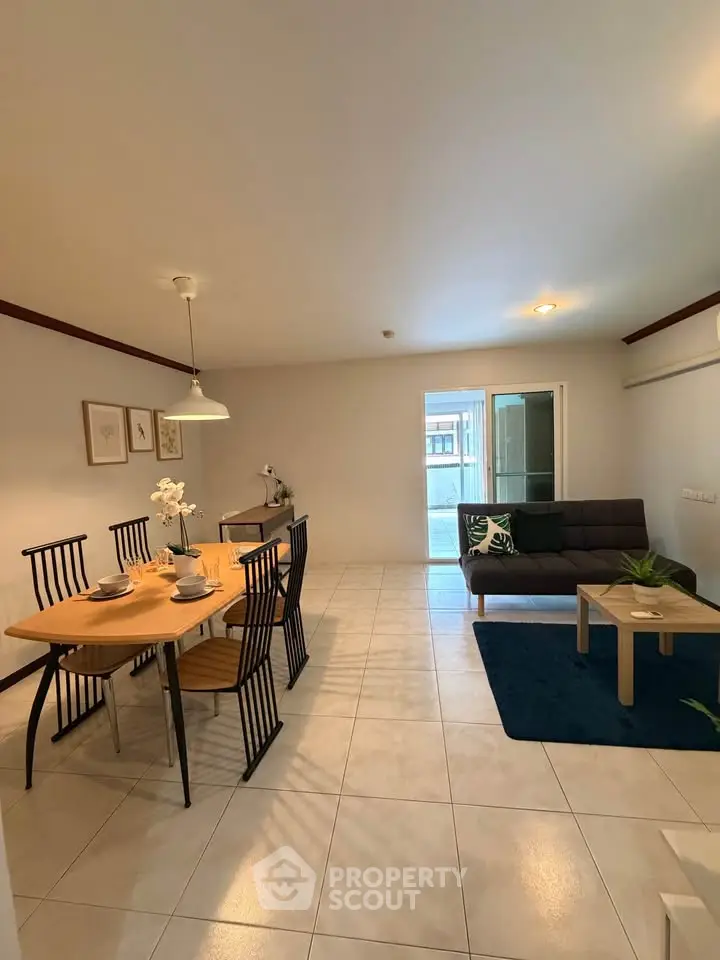 Spacious living room with dining area and modern decor in a bright apartment.