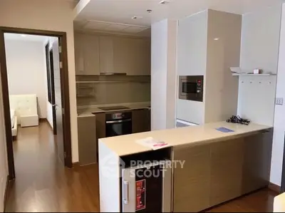 Modern kitchen with sleek cabinetry and built-in appliances in a stylish apartment.
