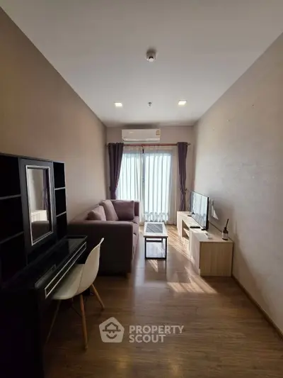 Modern living room with cozy sofa, TV, and elegant decor in a stylish apartment.