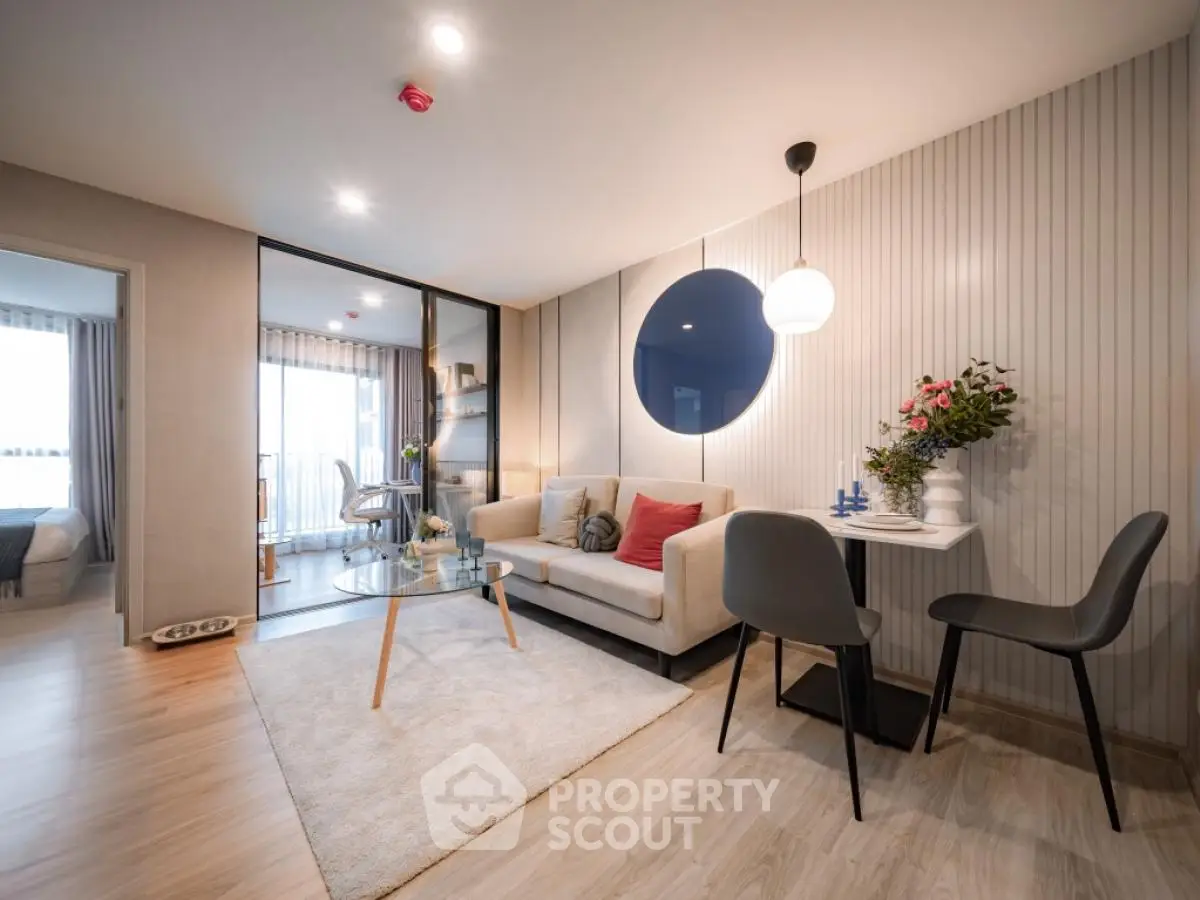 Modern living room with stylish decor and open layout, featuring a cozy seating area and elegant dining space.