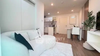 Modern living room with cozy white sofa and stylish open kitchen layout