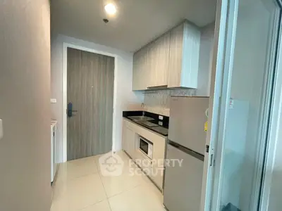 Modern kitchen with sleek cabinetry and stainless steel appliances in a compact layout.