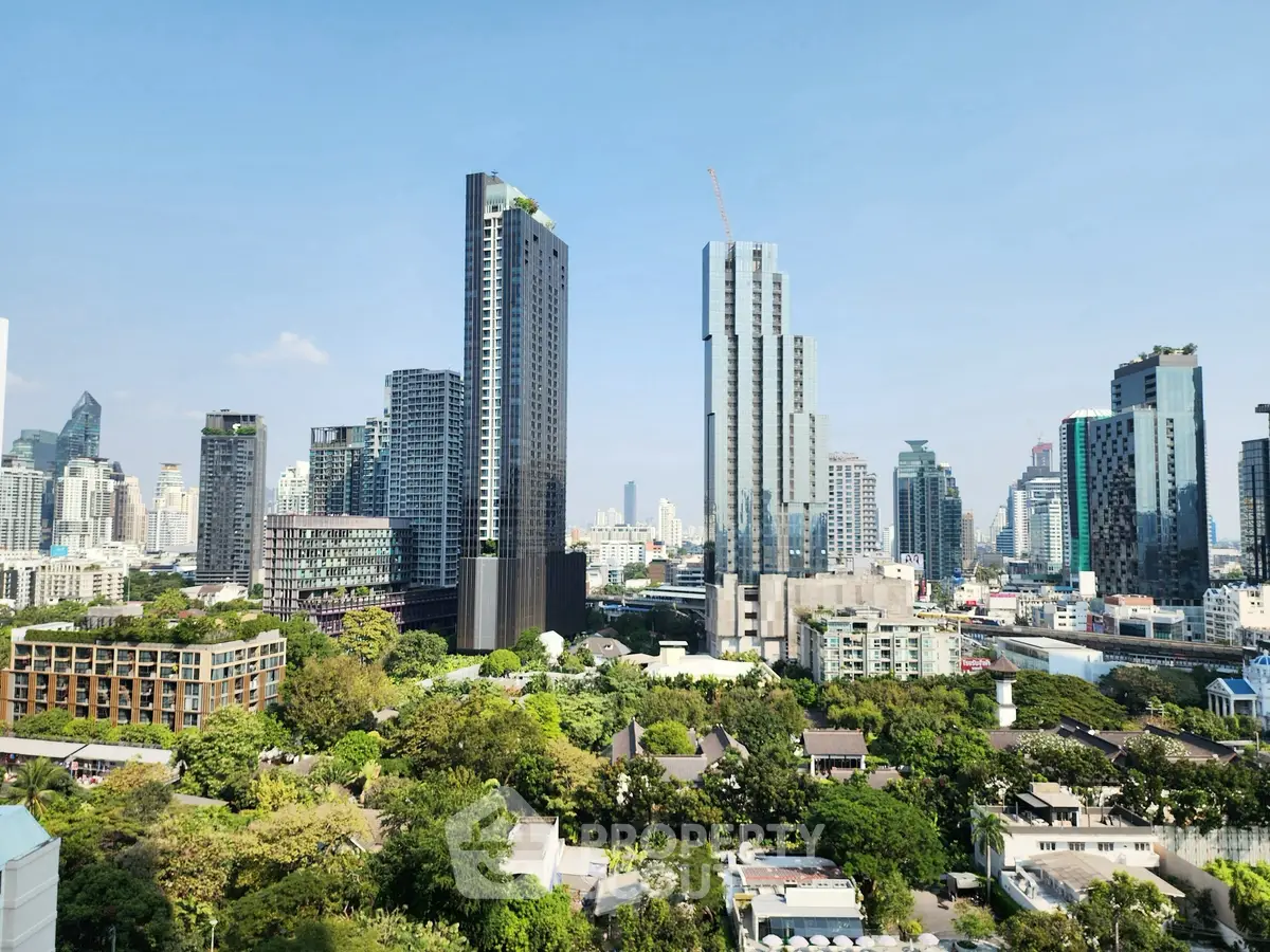 Stunning cityscape view with modern high-rise buildings and lush greenery, perfect for urban living.