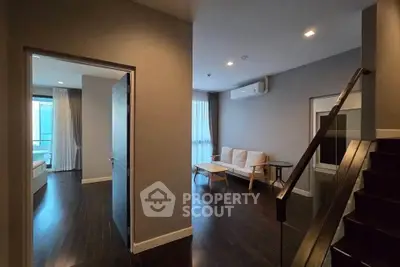 Modern duplex apartment with dark wood flooring and stylish living area