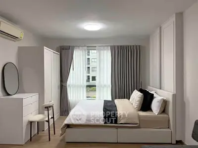 Modern bedroom with elegant decor and large window view