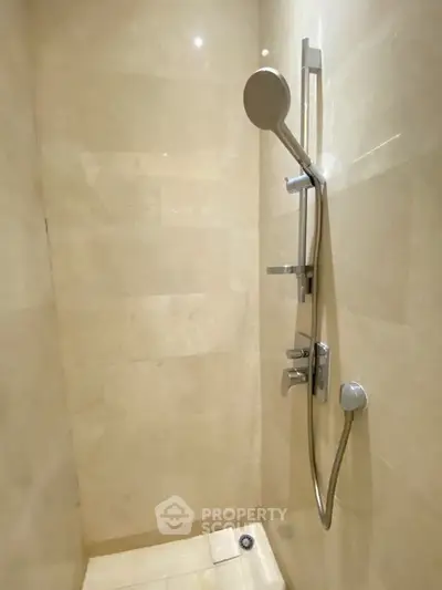 Modern bathroom shower with sleek fixtures and beige tiles