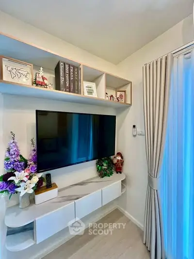 Modern living room with wall-mounted TV and stylish shelving