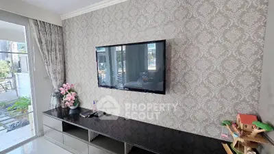 Stylish living room with wall-mounted TV and elegant decor