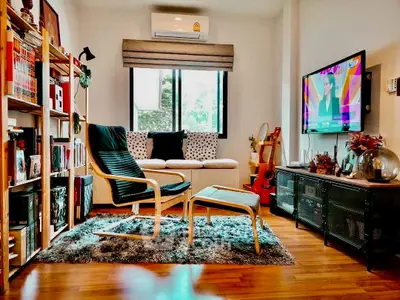 Cozy living room with modern decor, wooden flooring, and natural light.