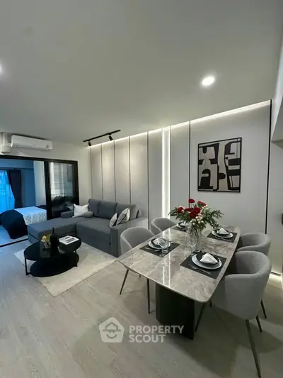 Modern open-plan living and dining area with stylish decor and cozy ambiance.