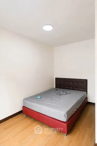 Minimalist bedroom with modern bed and wooden flooring