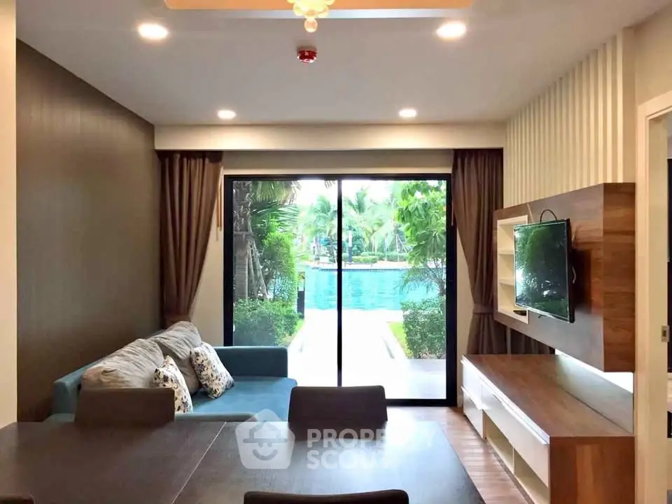 Modern living room with pool view and stylish decor