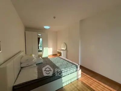Spacious bedroom with modern furnishings and ample natural light