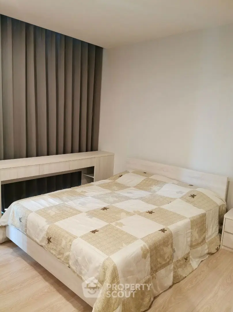 Cozy bedroom with modern decor and natural light, featuring a comfortable bed and stylish curtains.