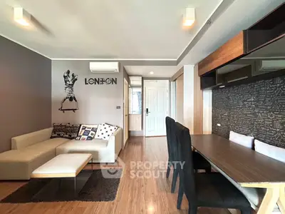Modern living room with stylish decor and dining area in a cozy apartment.