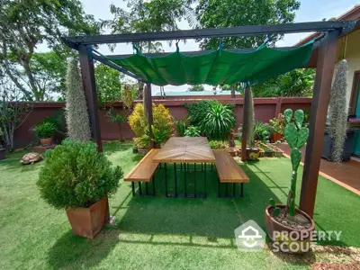 Charming garden with pergola and lush greenery, perfect for outdoor relaxation and entertainment.