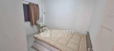 Cozy bedroom with polka dot bedding and a small vanity desk, perfect for a peaceful retreat.