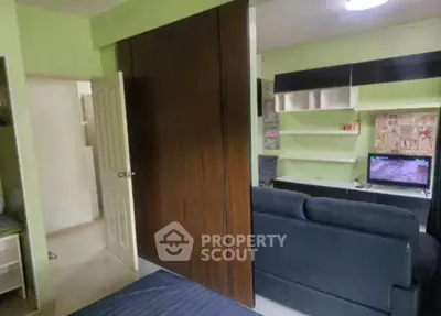 Modern living room with sleek furniture and built-in shelving, perfect for urban living.
