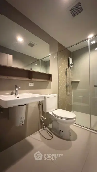 Modern bathroom with sleek fixtures and glass shower enclosure