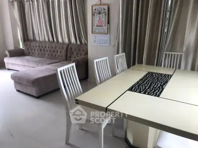 Spacious living and dining area with elegant furniture and natural light
