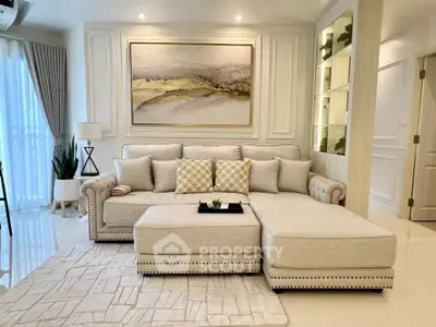 Luxurious living room with elegant beige sofa, stylish decor, and modern lighting in a sophisticated apartment.