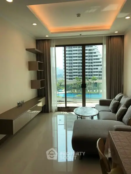 Modern living room with large windows and pool view in luxury apartment