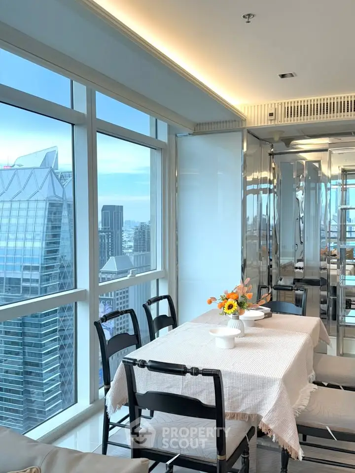 Luxurious dining area with stunning city view in high-rise apartment