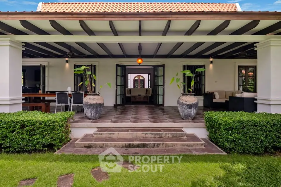 Charming villa with spacious patio and lush garden, perfect for outdoor entertaining and relaxation.