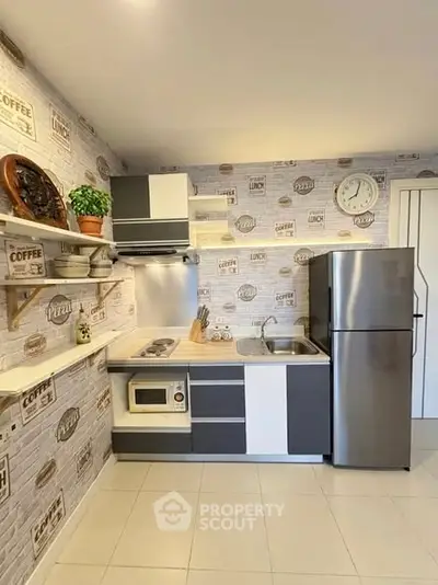 Modern kitchen with sleek appliances and stylish decor, featuring a stainless steel fridge and built-in oven.