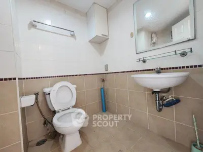 Spacious bathroom with modern fixtures and neutral tile design