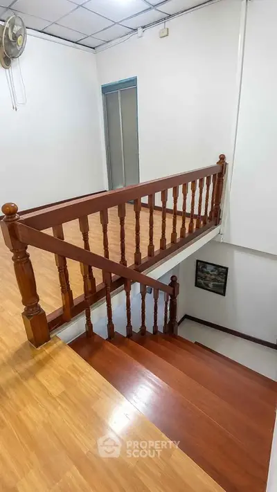 Charming wooden staircase with elegant railing in a cozy home interior
