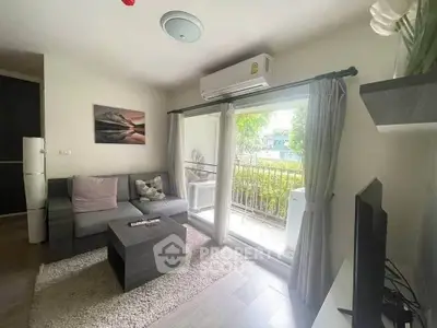 Cozy living room with modern decor and garden view, perfect for relaxation.