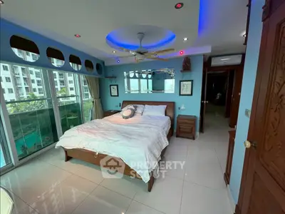 Luxurious bedroom with modern lighting and large windows overlooking a pool view.