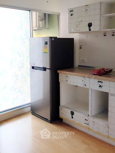 Modern kitchen with stainless steel fridge and ample storage space