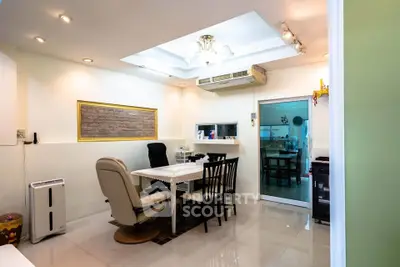 Modern dining area with elegant lighting and open layout, featuring a cozy seating arrangement and stylish decor.