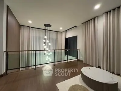 Elegant modern living space with stylish lighting and floor-to-ceiling curtains.