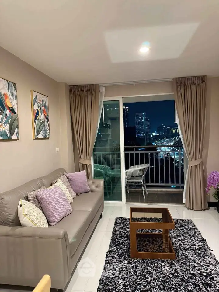 Chic living room with city view, modern decor, and cozy seating in a high-rise apartment.